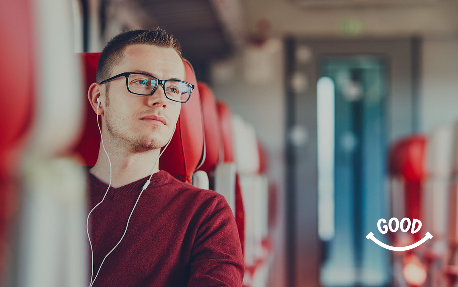 Man listening through earphones with the “Good” smile motif from The Good Mental Health Podcast.